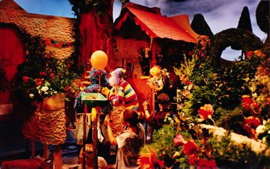 Showing the characters Woolley,Shelley and Rags with the puppeteers in the garden set.